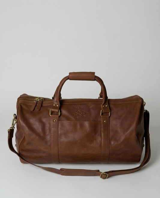 Brown leather duffel bag on a light gray background