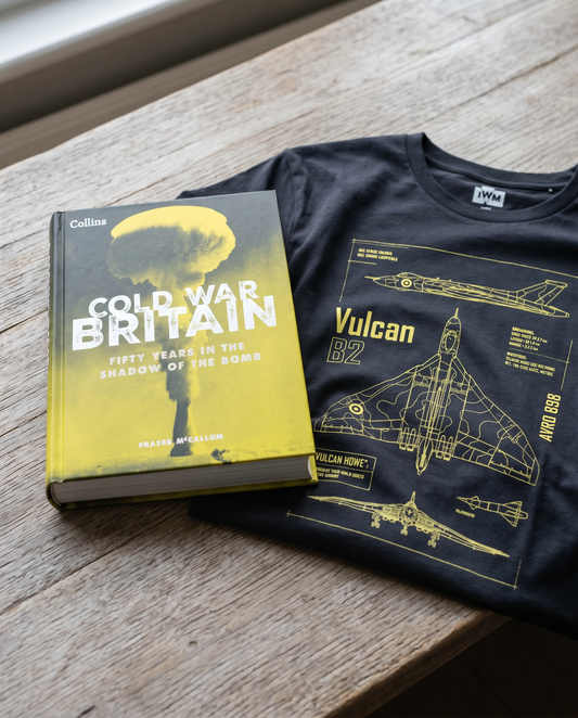 Book titled 'Cold War Britain' and a t-shirt with a design of a Vulcan bomber on a wooden surface.