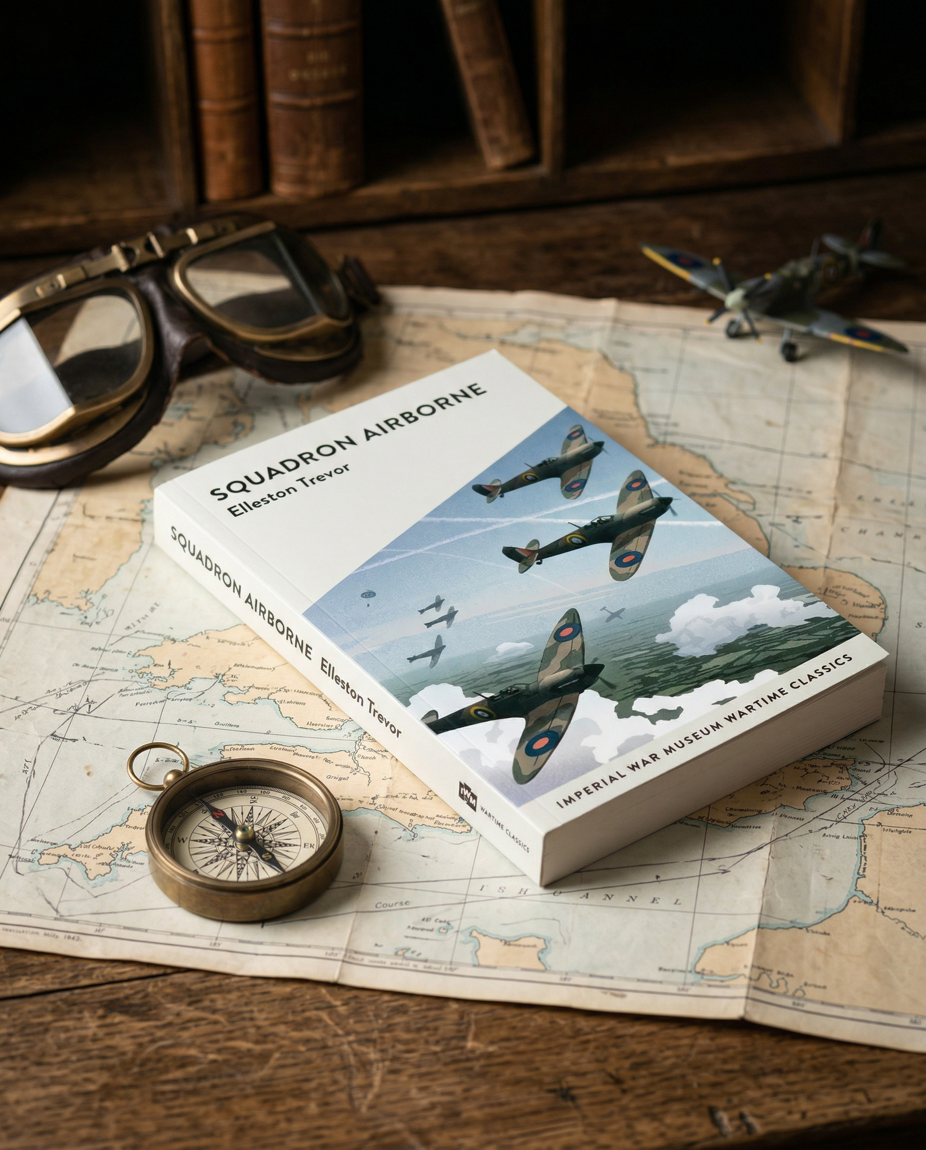 Book titled 'Squadron Airborne' on a map with goggles and compass