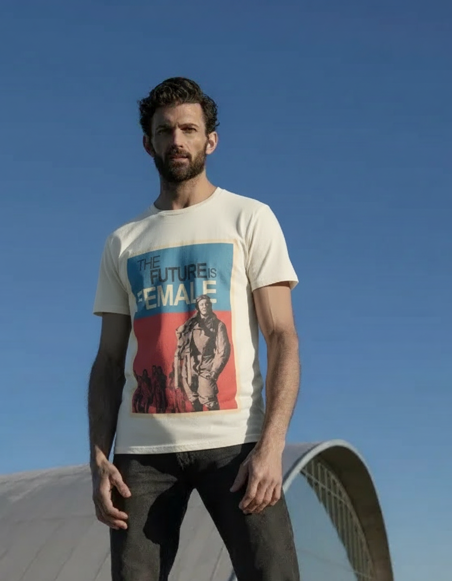 Man wearing a t-shirt with a graphic design against a clear blue sky